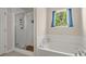 Bathroom featuring a soaking tub under a window with decoratively draped blue curtains at 162 Cherry Grv Dr, Summerville, SC 29483