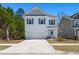 Charming two-story home with a well-manicured lawn and a delightful pink front door at 162 Cherry Grv Dr, Summerville, SC 29483