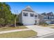 Charming two-story home with a well-manicured lawn, attached garage and pink front door at 162 Cherry Grv Dr, Summerville, SC 29483