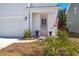 Inviting front entrance with a charming pink door, American flag, and well-kept landscaping at 162 Cherry Grv Dr, Summerville, SC 29483