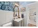 Stylish powder room with white wainscoting, blue wallpaper, and an ornate gold mirror at 162 Cherry Grv Dr, Summerville, SC 29483
