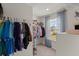 Walk-in closet with clothing racks, shelving, and a bright window with draped blue curtains at 162 Cherry Grv Dr, Summerville, SC 29483