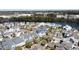 An aerial view of upscale homes nestled on waterfront property, with lush greenery and tree-lined streets at 1676 Paradise Lake Dr, Mount Pleasant, SC 29464
