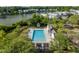 Aerial view of community pool, clubhouse, and surrounding homes near the waterfront and lush landscaping at 1676 Paradise Lake Dr, Mount Pleasant, SC 29464