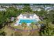 Aerial view of community pool surrounded by lush landscaping and charming residential homes at 1676 Paradise Lake Dr, Mount Pleasant, SC 29464