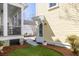 Side yard with artificial turf, access to porch and back patio, and convenient side entrance at 1676 Paradise Lake Dr, Mount Pleasant, SC 29464