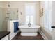 Bright bathroom featuring a luxurious standalone tub, shower, and neutral walls at 1676 Paradise Lake Dr, Mount Pleasant, SC 29464