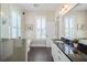 Sun-filled bathroom showcasing a glass shower, tub, and vanity with granite counters at 1676 Paradise Lake Dr, Mount Pleasant, SC 29464