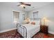 Cozy bedroom featuring wood floors, ceiling fan, and two windows at 1676 Paradise Lake Dr, Mount Pleasant, SC 29464