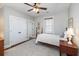 Bedroom featuring wood floors, double door closet, ceiling fan, and window at 1676 Paradise Lake Dr, Mount Pleasant, SC 29464