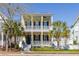 Charming yellow two-story home with double porches, shutters, and well-maintained landscaping at 1676 Paradise Lake Dr, Mount Pleasant, SC 29464
