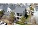 Charming yellow two-story home with double porches, gray roof, and neat landscaping at 1676 Paradise Lake Dr, Mount Pleasant, SC 29464