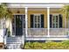 Inviting front porch with white railings, steps, and lush green landscaping at 1676 Paradise Lake Dr, Mount Pleasant, SC 29464