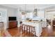 Bright kitchen features an island with granite countertops, stainless steel appliances, and modern pendant lighting at 1676 Paradise Lake Dr, Mount Pleasant, SC 29464