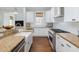 An ample kitchen with granite countertops, stainless steel appliances, and a white farmhouse sink at 1676 Paradise Lake Dr, Mount Pleasant, SC 29464