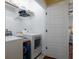 Bright laundry room featuring a washer, dryer, and storage shelves at 1676 Paradise Lake Dr, Mount Pleasant, SC 29464
