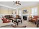 Inviting living room featuring a fireplace, elegant furniture, and a view into the dining room at 1676 Paradise Lake Dr, Mount Pleasant, SC 29464