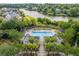Aerial view of a beautiful community pool surrounded by palm trees and lush landscaping at 1676 Paradise Lake Dr, Mount Pleasant, SC 29464