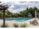 Community pool featuring sun loungers, landscaping, and a pergola with a shady seating area at 1676 Paradise Lake Dr, Mount Pleasant, SC 29464