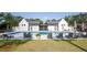 Community pool with lounge chairs and nearby changing cabanas for residents to enjoy a relaxing day at 1676 Paradise Lake Dr, Mount Pleasant, SC 29464
