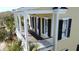 Cozy porch with rocking chairs, white railing, black shutters and wood-look floor at 1676 Paradise Lake Dr, Mount Pleasant, SC 29464
