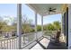 Charming porch with rocking chair overlooking tree-lined street at 1676 Paradise Lake Dr, Mount Pleasant, SC 29464