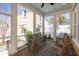 Relaxing screened porch with rocking chairs and wood bench, perfect for enjoying the outdoors at 1676 Paradise Lake Dr, Mount Pleasant, SC 29464