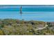 Scenic view of a historic lighthouse standing tall amidst the vast ocean and lush green landscape at 1699 E Ashley Ave # B, Folly Beach, SC 29439