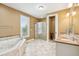 Large bathroom with a soaking tub, walk-in shower, and double vanity sinks at 1699 E Ashley Ave # B, Folly Beach, SC 29439