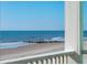 Beautiful beach view from the porch of this luxurious home with blue skies and rolling waves at 1699 E Ashley Ave # B, Folly Beach, SC 29439
