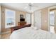 Comfortable bedroom with white linens, ceiling fan, dresser and TV, plus ocean views at 1699 E Ashley Ave # B, Folly Beach, SC 29439