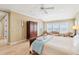 Spacious bedroom with an armoire, ceiling fan, and access to a scenic balcony at 1699 E Ashley Ave # B, Folly Beach, SC 29439