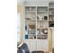 Built-in bookshelf with display cabinets, crown molding, and decorative beach-themed ornaments at 1699 E Ashley Ave # B, Folly Beach, SC 29439