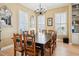 Traditional dining room featuring a dark wood table, seating for eight, and bright natural light from shuttered windows at 1699 E Ashley Ave # B, Folly Beach, SC 29439