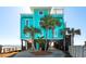 Bright, modern home with turquoise siding and palm trees on a beachside property at 1699 E Ashley Ave # B, Folly Beach, SC 29439