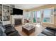 Bright living room with fireplace, built-ins, and access to a balcony overlooking the ocean at 1699 E Ashley Ave # B, Folly Beach, SC 29439