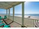 Outdoor porch features ocean view, white railing, and colorful Adirondack seating at 1699 E Ashley Ave # B, Folly Beach, SC 29439