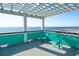 Enjoy the ocean breeze from the rooftop deck featuring a pergola and seating for outdoor relaxation at 1699 E Ashley Ave # B, Folly Beach, SC 29439