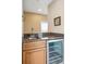 Wet bar area featuring granite countertops, wood cabinets, stainless sink, and a wine refrigerator at 1699 E Ashley Ave # B, Folly Beach, SC 29439