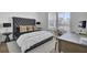 Bright bedroom featuring a plush bed, stylish pillows, and a desk near the window at 201 Symphony Ave, Summerville, SC 29486