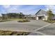 Exterior of the clubhouse with gray brick entrance and meticulous landscaping at 201 Symphony Ave, Summerville, SC 29486