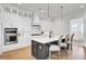 Bright kitchen featuring an island, white cabinetry, stainless appliances, and pendant lighting at 201 Symphony Ave, Summerville, SC 29486