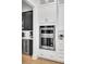 Modern kitchen boasts stainless KitchenAid appliances, quartz counters, and custom cabinetry at 201 Symphony Ave, Summerville, SC 29486
