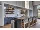 A kitchenette with ample counter space, bar stool seating and open shelving at 201 Symphony Ave, Summerville, SC 29486