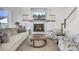 Inviting living room featuring a fireplace with a light blue mantle, a cream-colored couch, and stylish armchairs at 201 Symphony Ave, Summerville, SC 29486