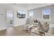 Bright living room featuring a white couch, light hardwood floors, and a wall-mounted television at 201 Symphony Ave, Summerville, SC 29486