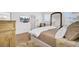 Serene main bedroom with plush bedding, wood floors, an arched mirror, and a wall-mounted TV at 201 Symphony Ave, Summerville, SC 29486