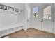 Bright mudroom with shiplap walls, cubbies, and a wood floor perfect for organization near the entryway at 201 Symphony Ave, Summerville, SC 29486