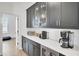 Walk-in pantry with dark shaker cabinets, white quartz counters, wine cooler and coffee bar at 201 Symphony Ave, Summerville, SC 29486