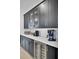 Walk-in pantry with dark shaker cabinets, white quartz counters, wine cooler and coffee bar at 201 Symphony Ave, Summerville, SC 29486